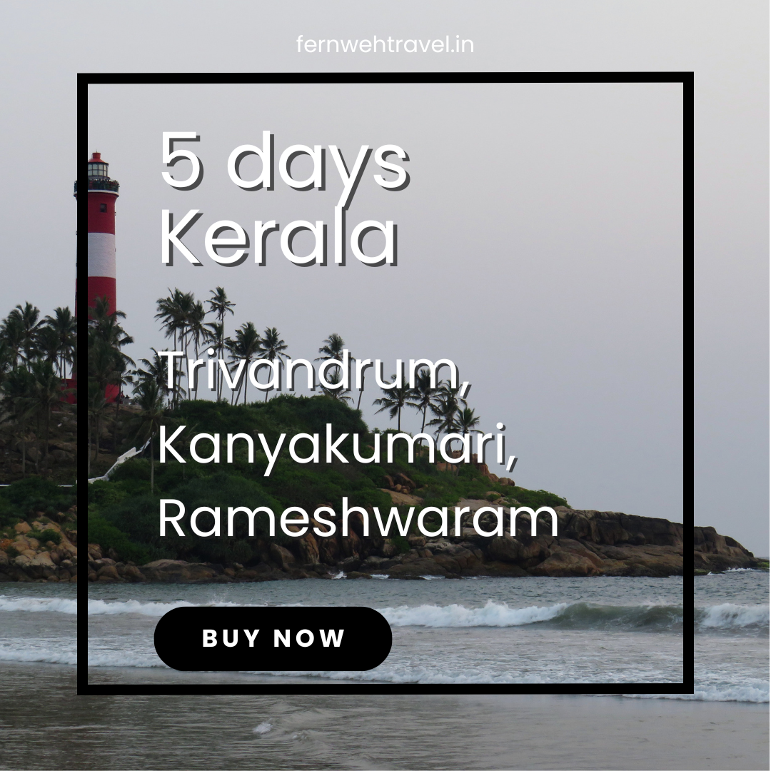 A tall white lighthouse standing on a sun-kissed beach, overlooking the Arabian Sea.