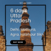 Qutub Minar standing tall with blue sky in Delhi, representing historical grandeur