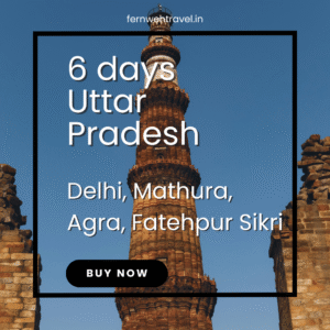 Qutub Minar standing tall with blue sky in Delhi, representing historical grandeur