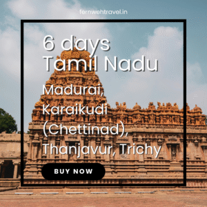 Brihadeeswarar Temple in Thanjavur under blue skies, showcasing towering Dravidian architecture and intricately carved granite.