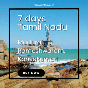 Thiruvalluvar Statue towering over the sea in Kanyakumari, with blue skies and ocean waves symbolizing wisdom and serenity.